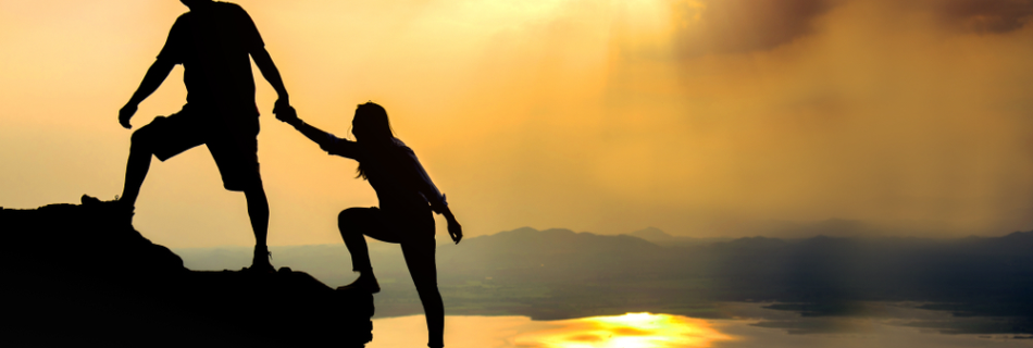 Teamwork friendship hiking help each other trust assistance silhouette in mountains, sunrise