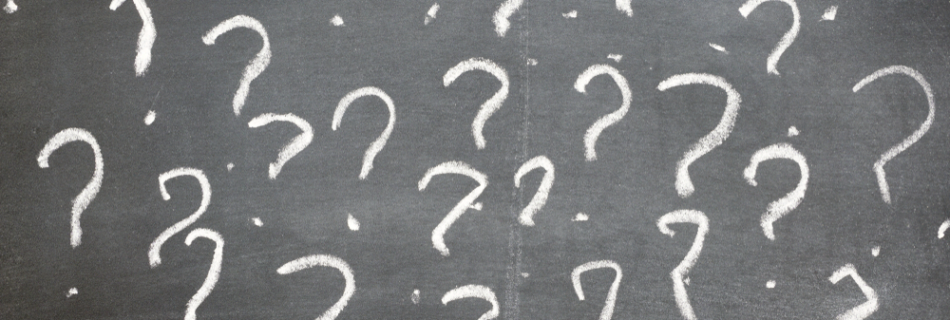 Question marks on a blackboard