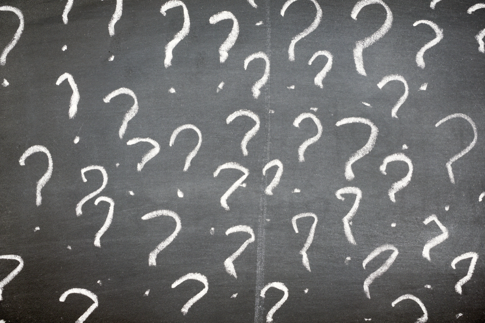 Question marks on a blackboard